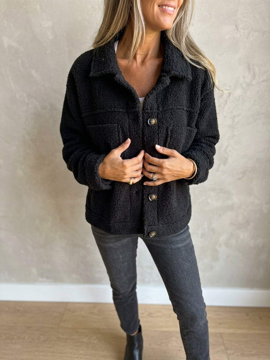 Model wearing black sherpa cardigan