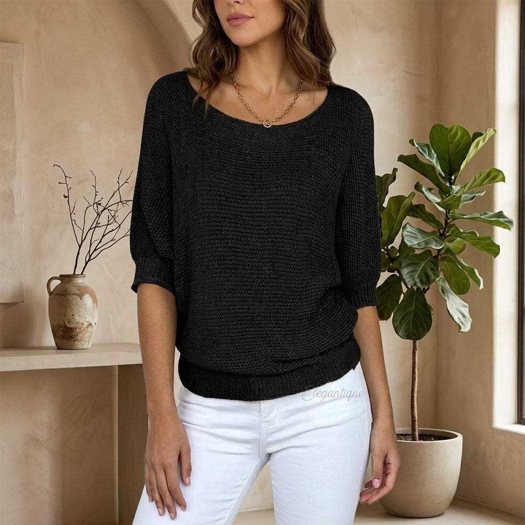 Model wearing black short-sleeve knit sweater