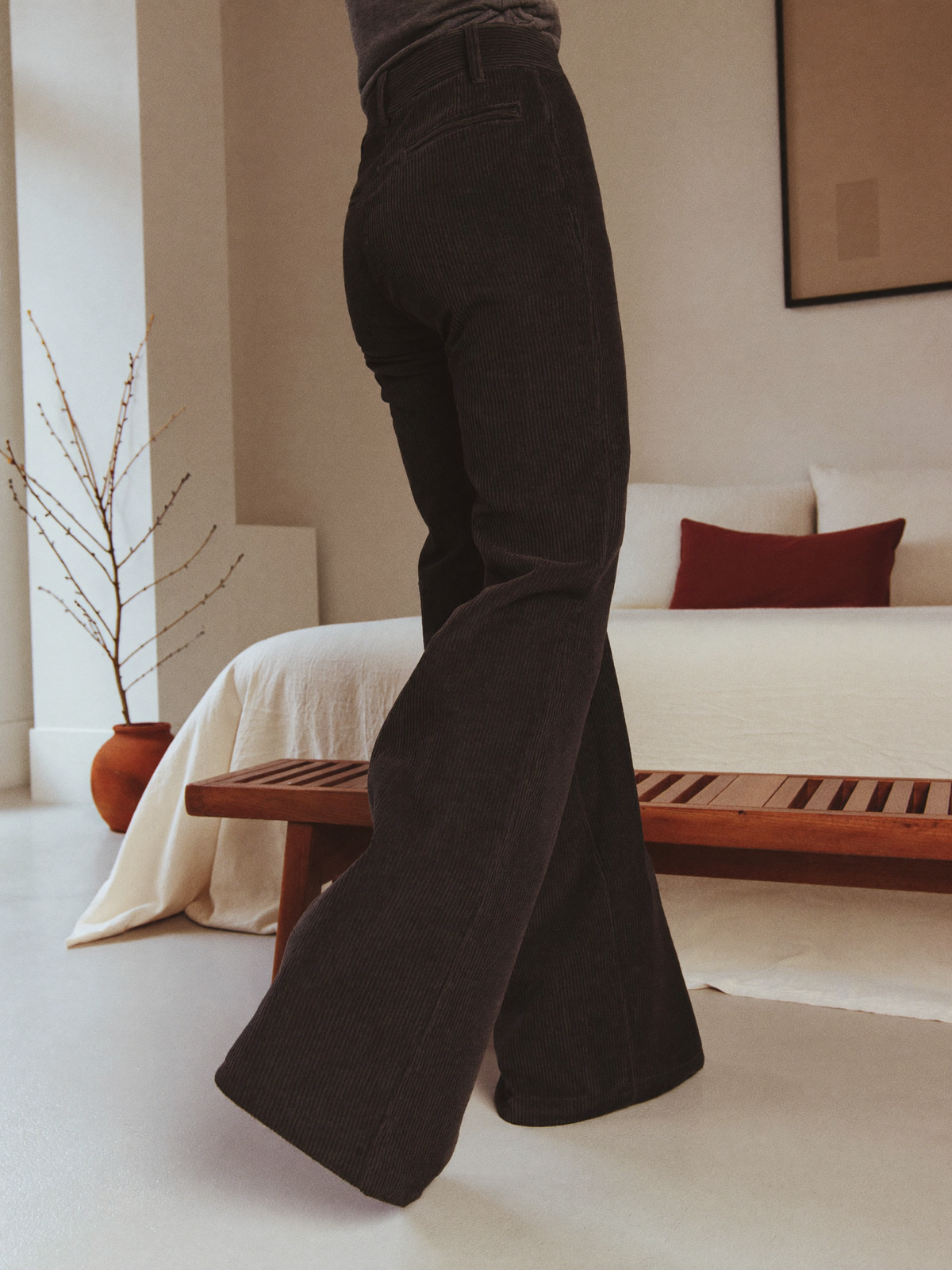 Model wearing black flared trousers, lifestyle