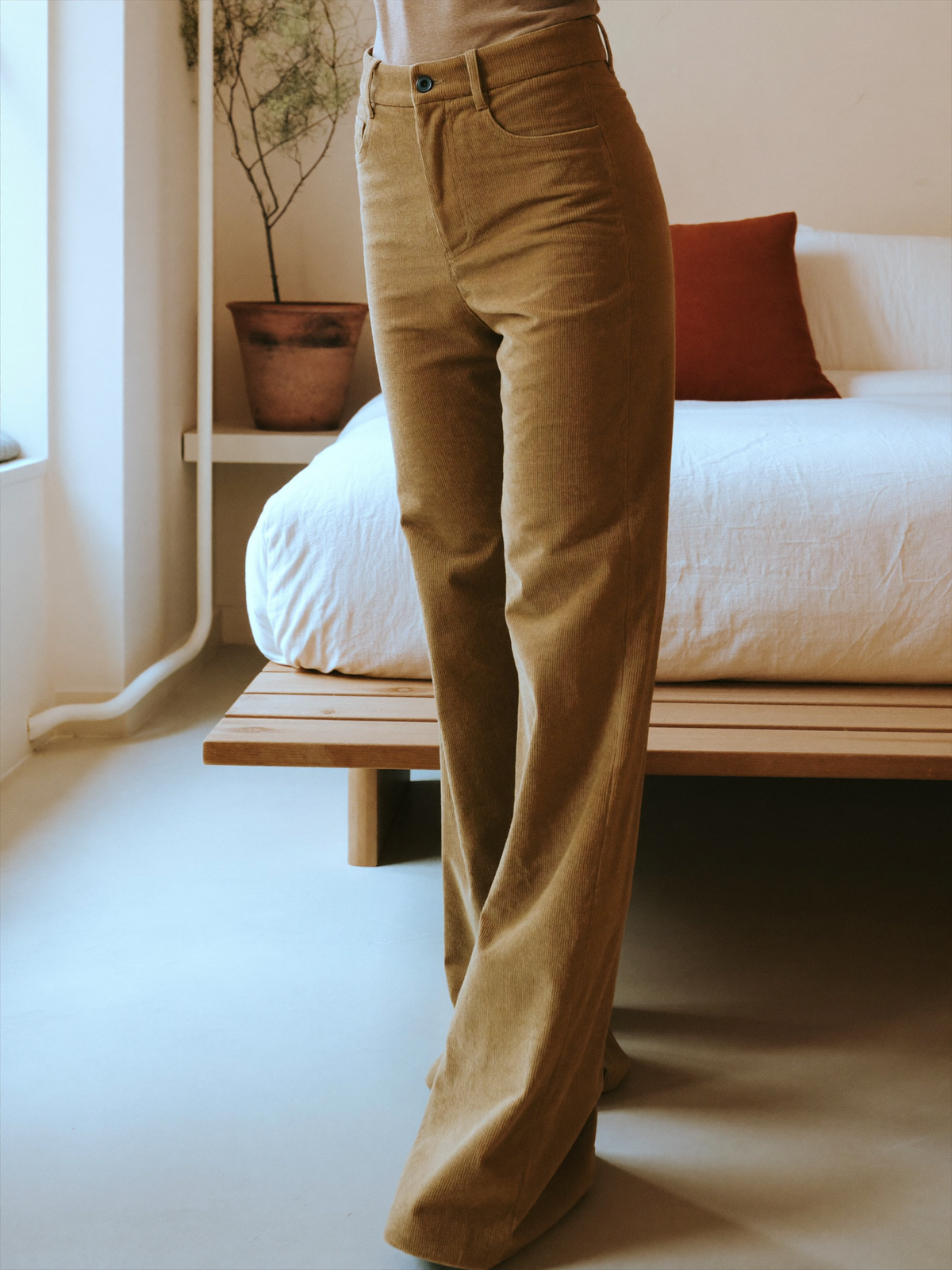 Model wearing khaki flared trousers, lifestyle