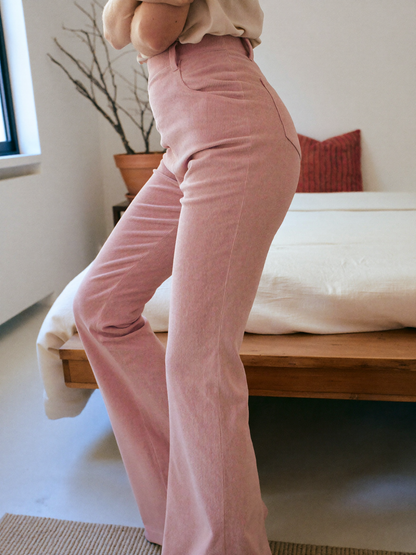 Model wearing pink flared trousers, lifestyle
