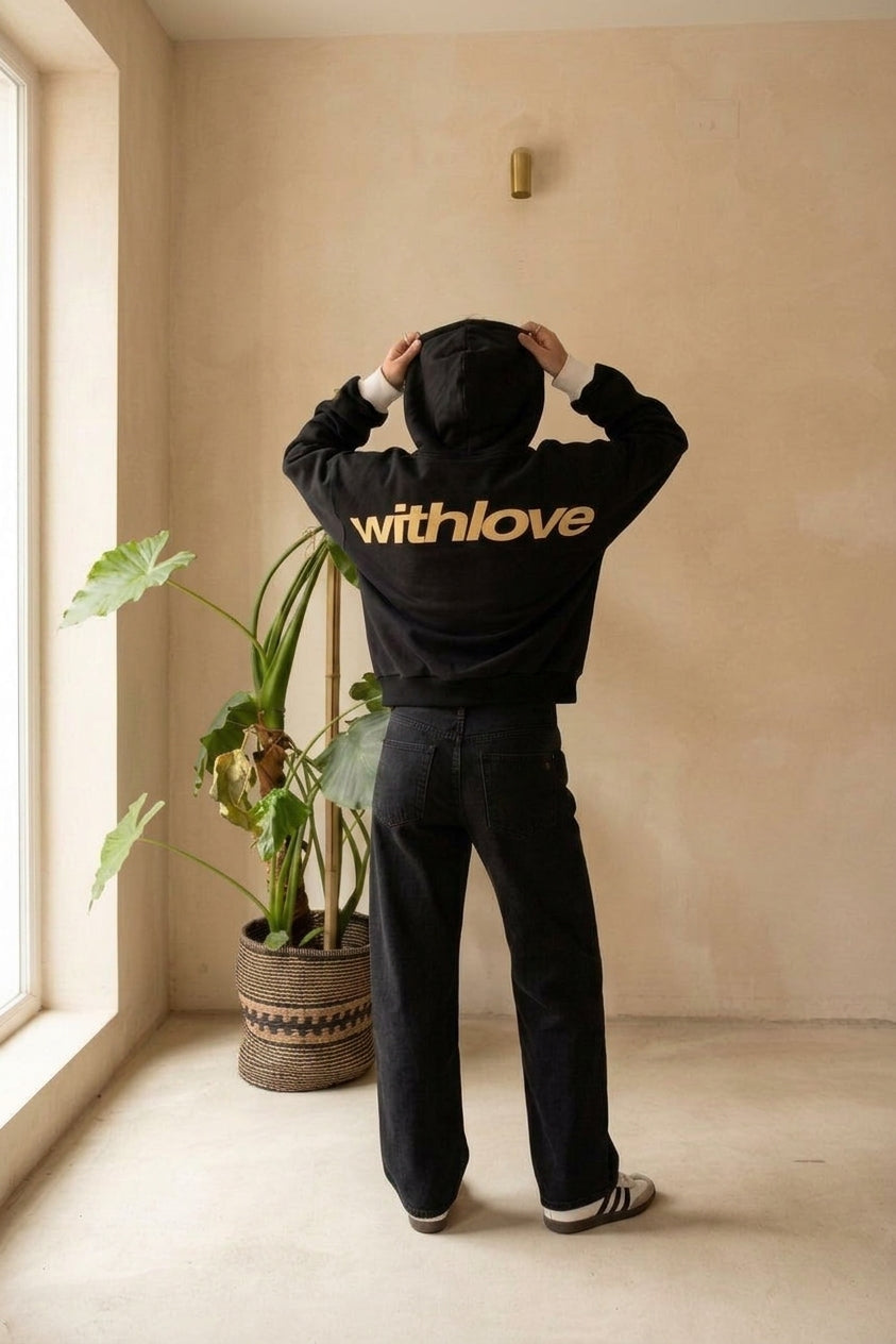 Model wearing black and yellow oversized hoodie