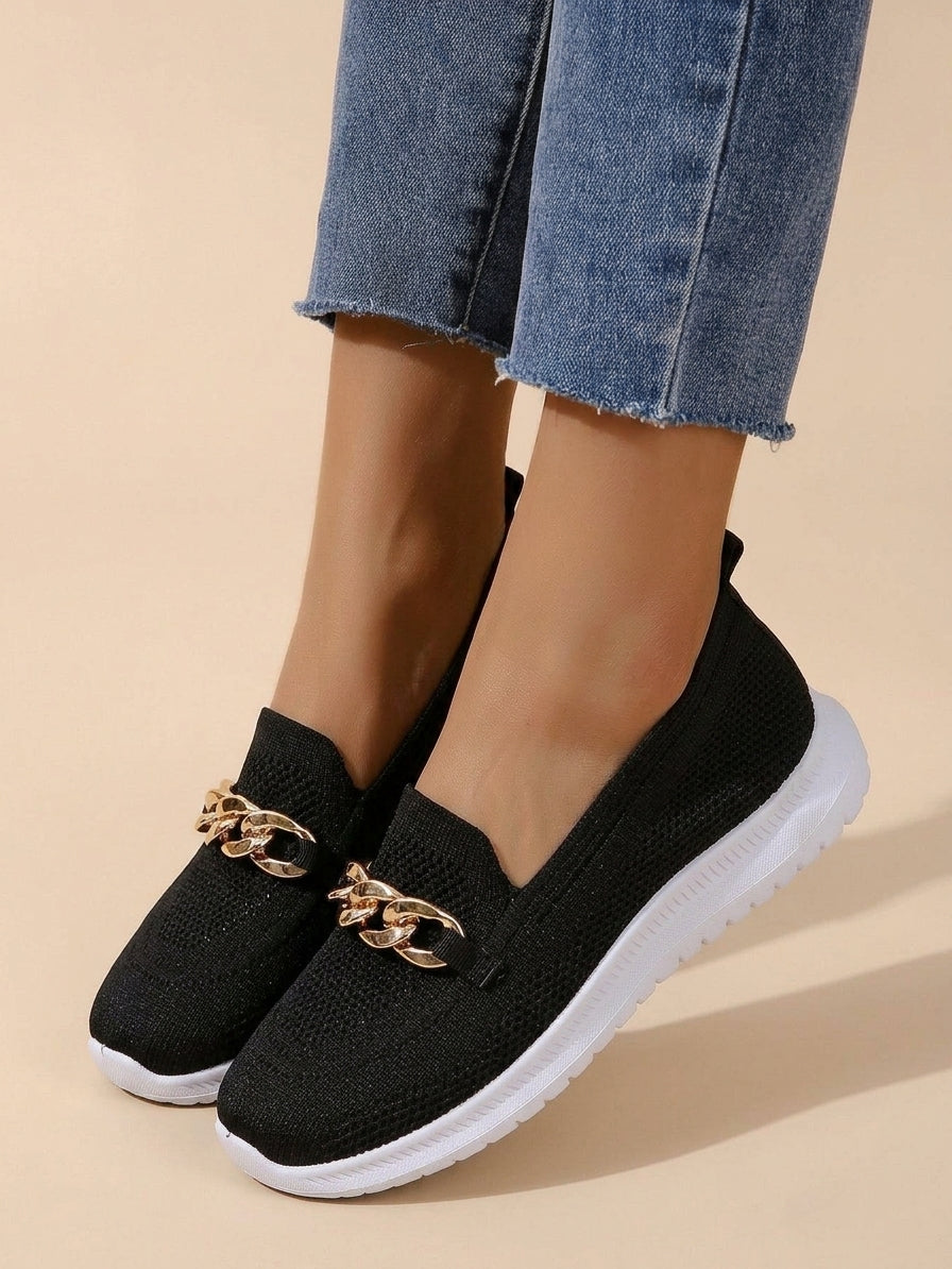 Black knit slip-on sneaker with gold chain accent