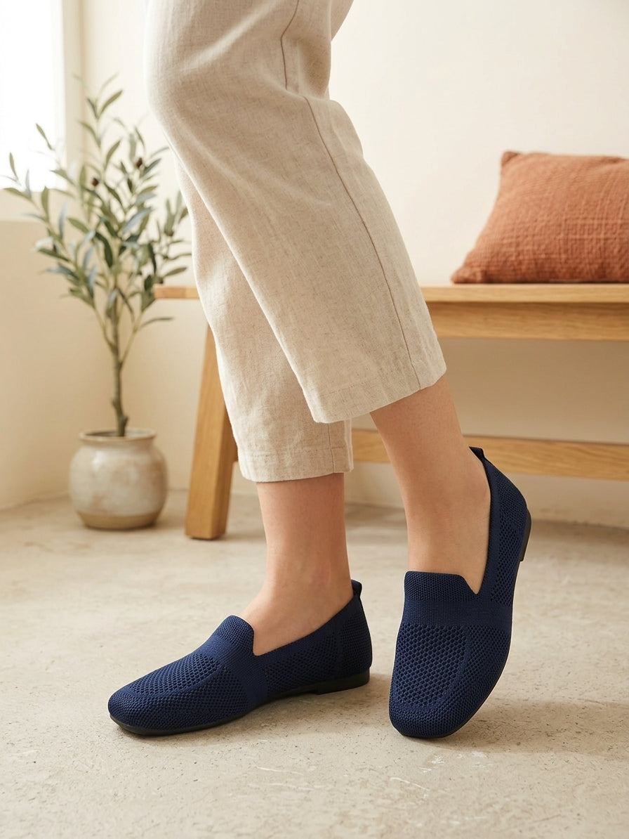 Model wearing navy knit slip-on flats