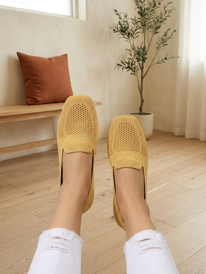 Model wearing yellow knit slip-on flats