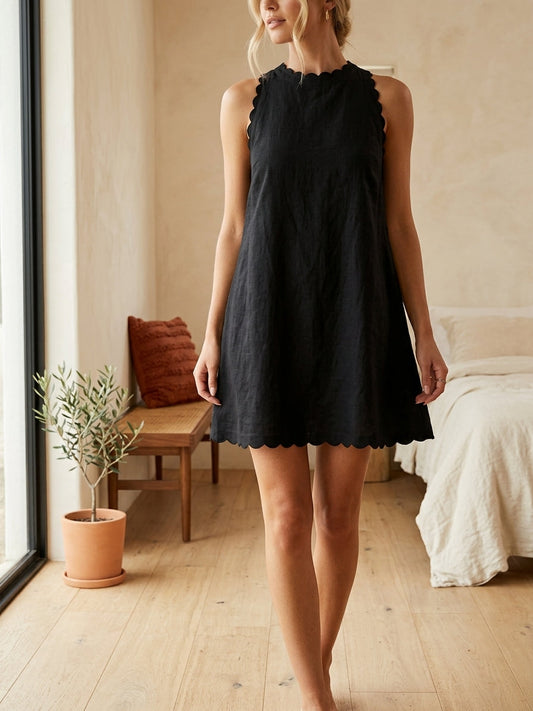Model wearing black scalloped A-line dress