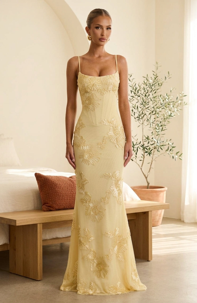 Model wearing yellow floral corset maxi dress