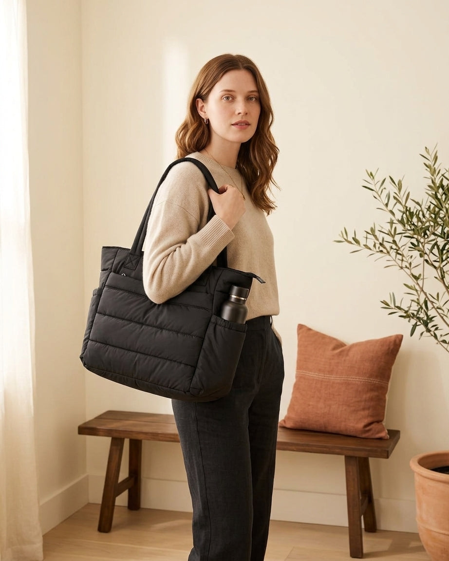 Model with black puffer tote
