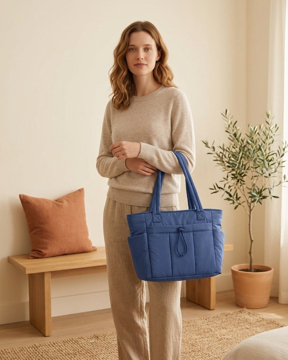 Model with blue puffer tote