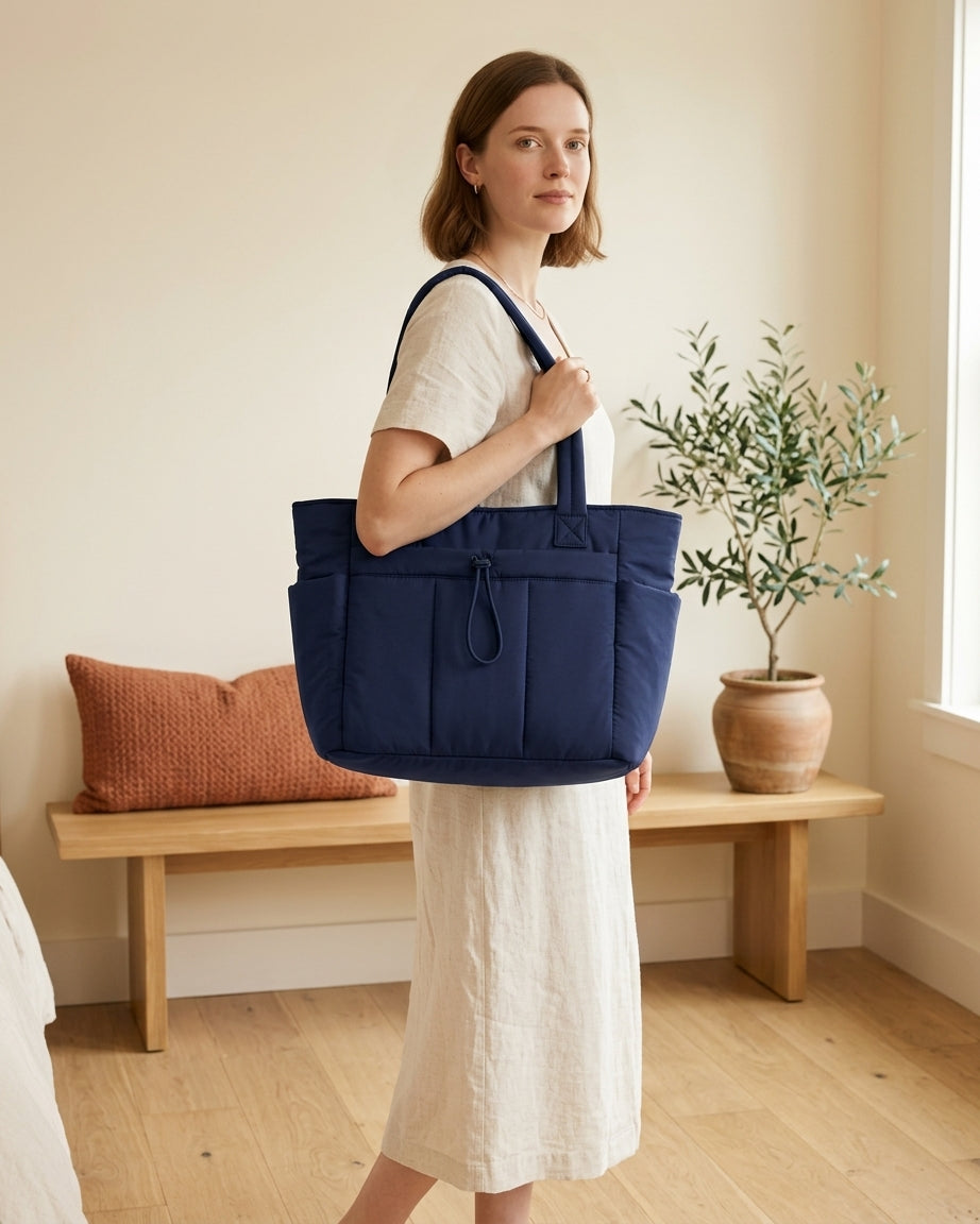 Model with navy blue puffer tote