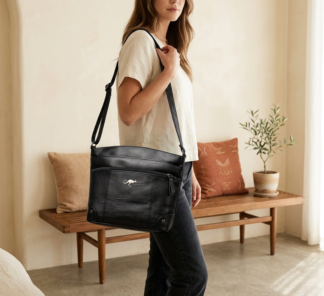Model with black vintage leather shoulder bag