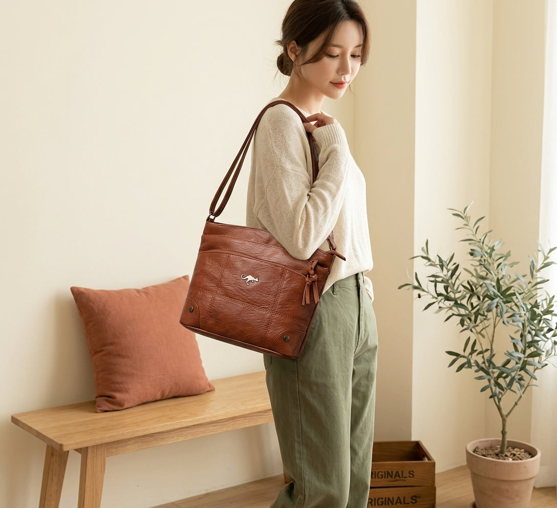 Model with brown vintage leather shoulder bag