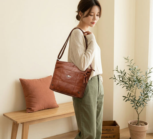 Model with brown vintage leather shoulder bag